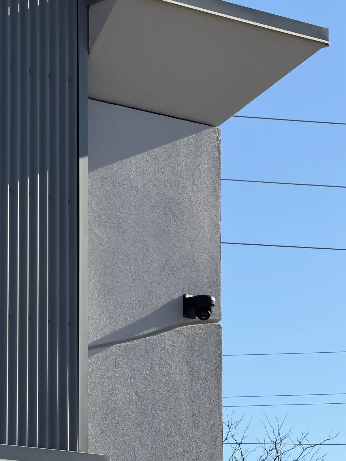 Black dome camera on the exterior of a modern commercial building